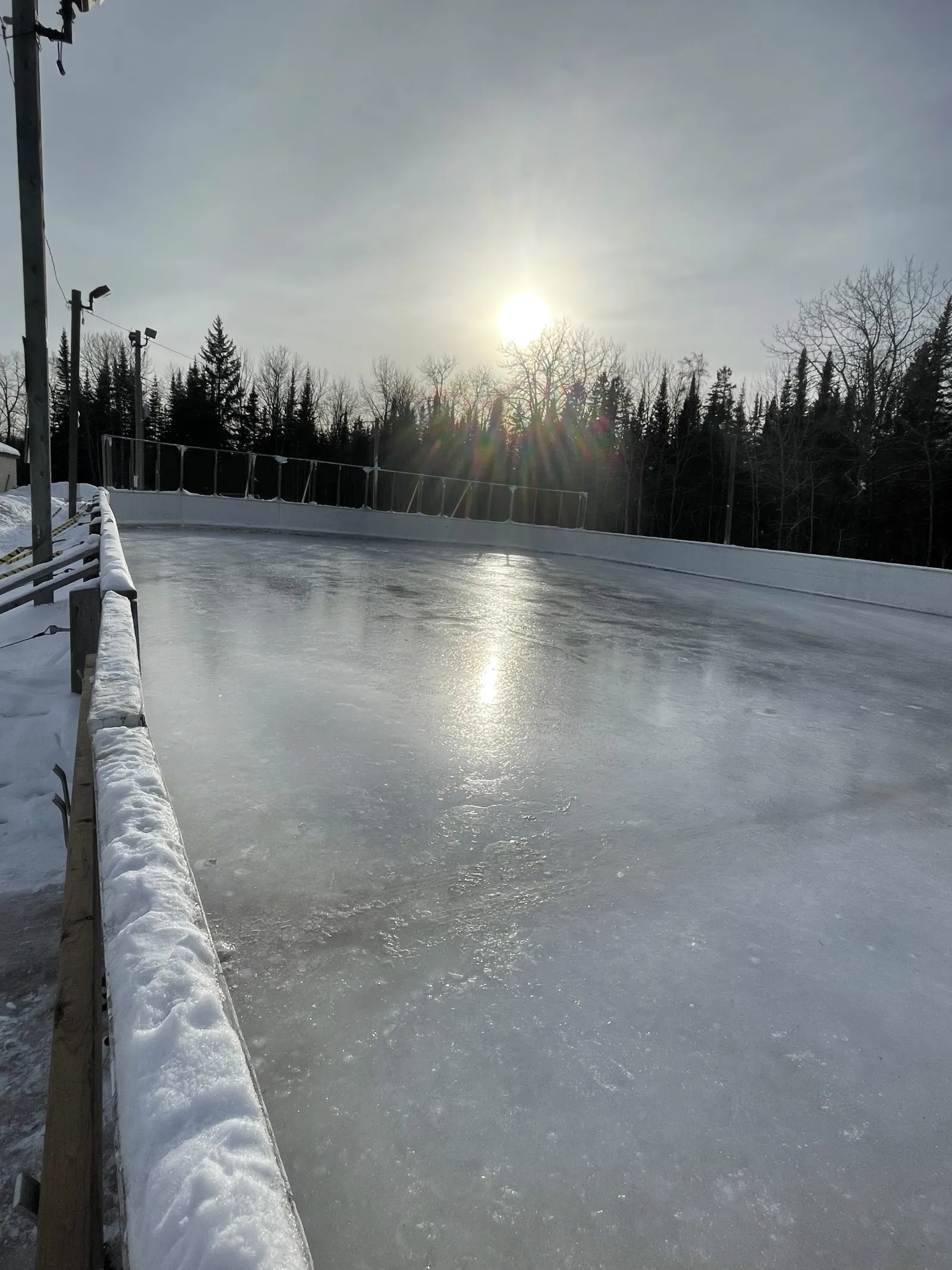 The boarded rink at North McIntyre Community Centre with a smooth sheet of ice — North McIntyre Community Centre Outdoor Rinks