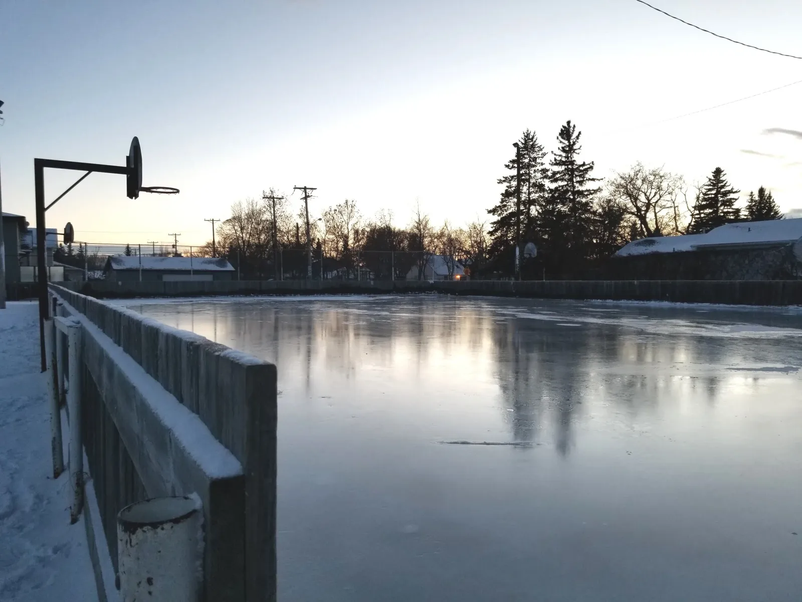 North Park Wilson School outdoor rink ice at dusk (North Park / Richmond Heights Community Association rink page) — North Park Wilson School Outdoor Rink (North Park / Richmond Heights)