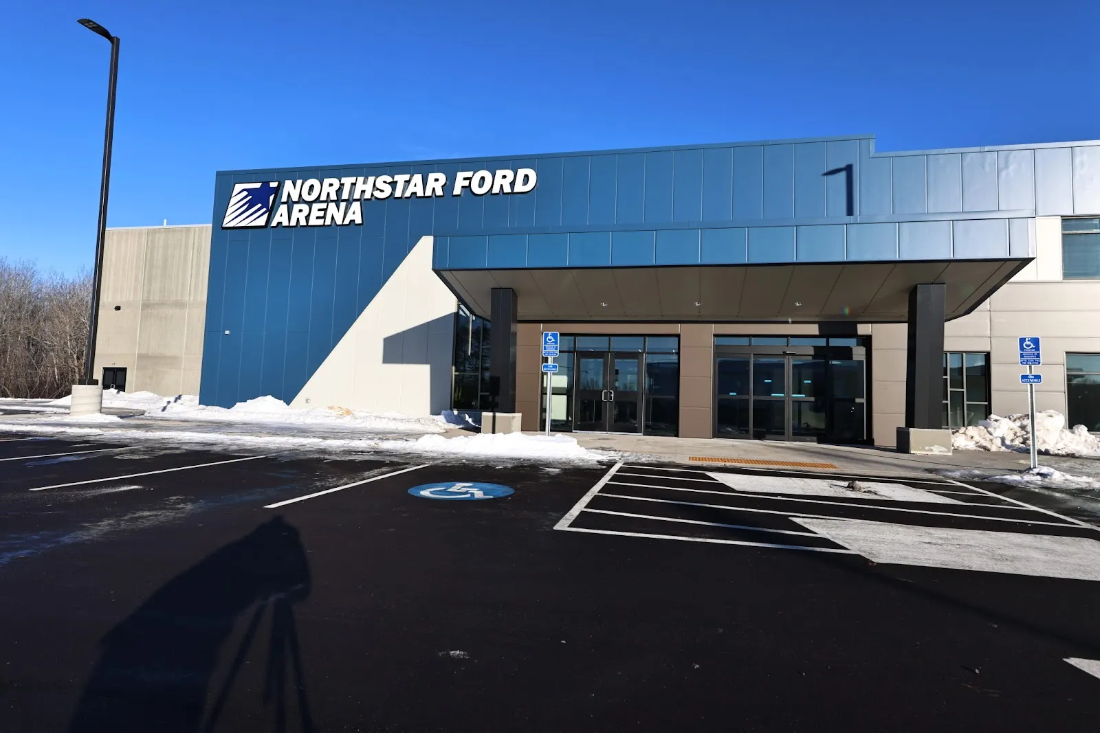 The Northstar Ford Arena entrance canopy and sign in Hermantown on a sunny winter day — NorthStar Ford Arena