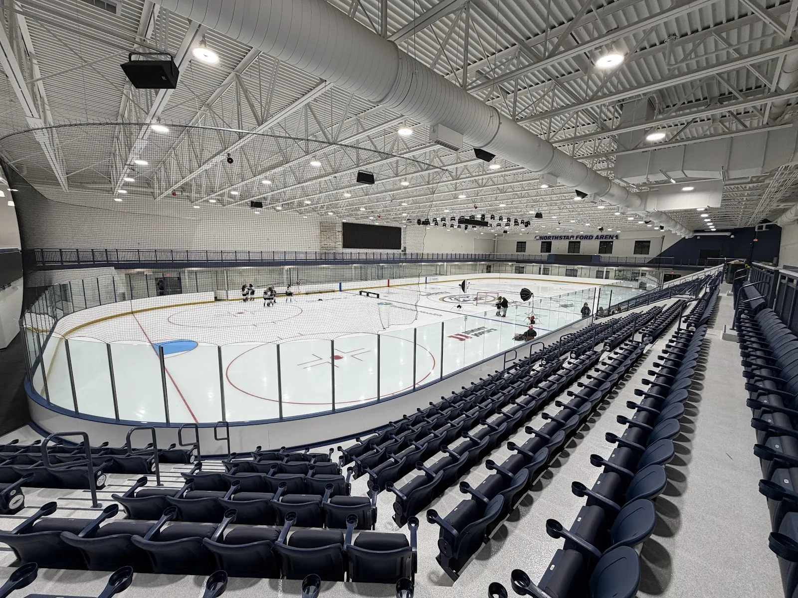 The Northstar Ford Arena ice sheet and seating bowl, seen from the stands before play — NorthStar Ford Arena
