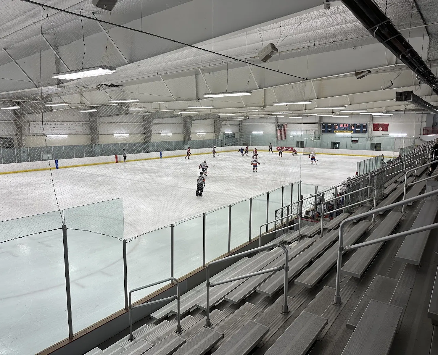 One of the Northtown Center sheets seen from the upper bleachers during a game, with the scoreboard at the far end — Northtown Center at Amherst