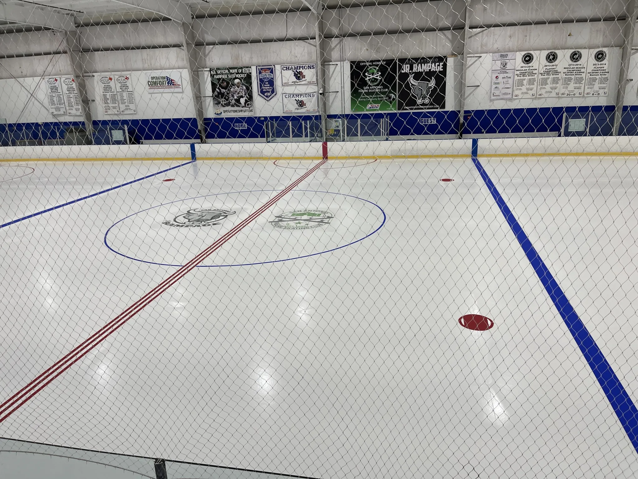 Freshly painted ice photographed through the end netting — Ice & Golf Center at Northwoods