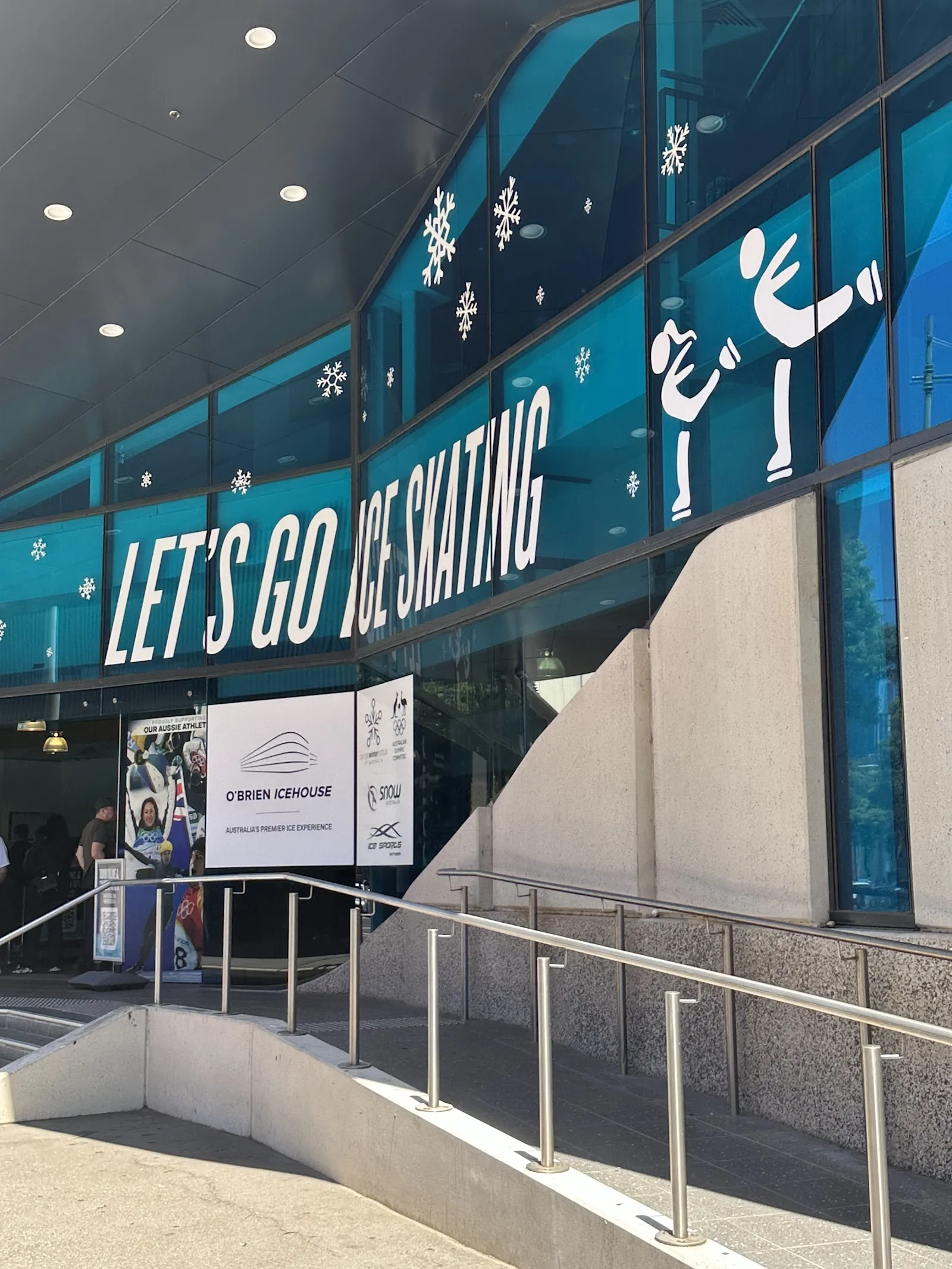 The glass facade and ramp at the entrance of O'Brien Icehouse in Docklands — O'Brien Icehouse