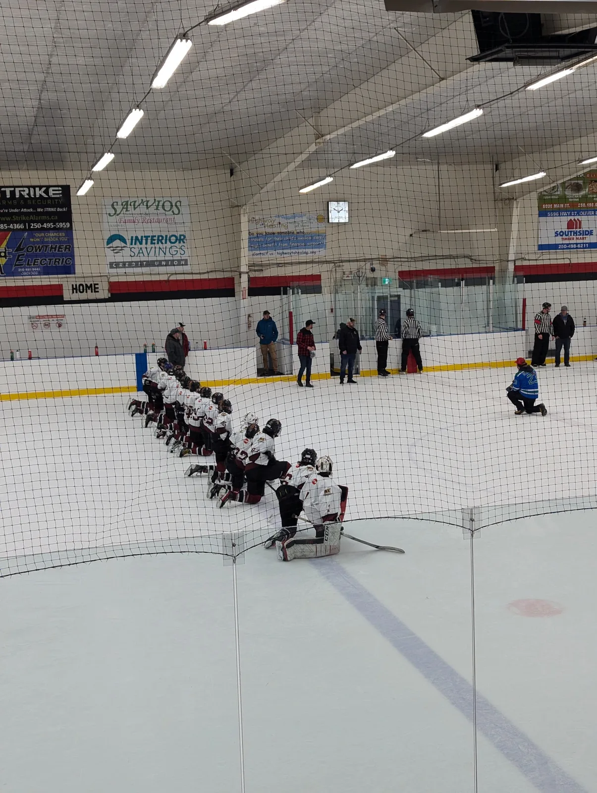 The ice at the Oliver & District Arena with a team lined up along the boards — Oliver & District Arena