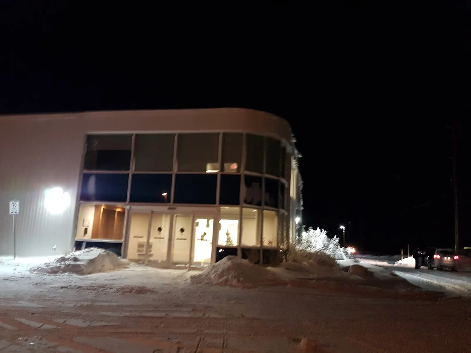 The glass entrance of the Oro-Medonte Community Arena at night — Oro-Medonte Community Arena