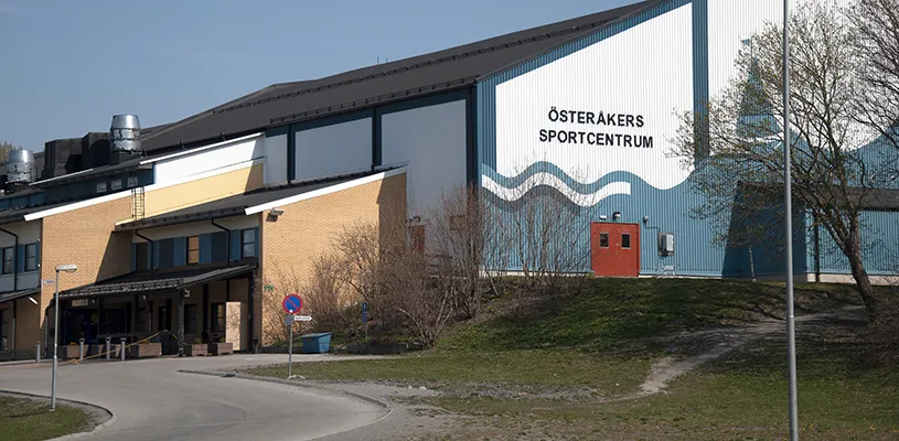 Österåkers sportcentrum on Hackstavägen, the building that holds the two ishallar, seen from the access road in spring — Österåkers ishallar
