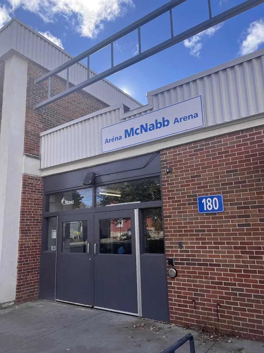 The McNabb Arena entrance at 180 Percy Street, grey doors under a metal-clad band with the arena's name. — McNabb Arena and Community Centre