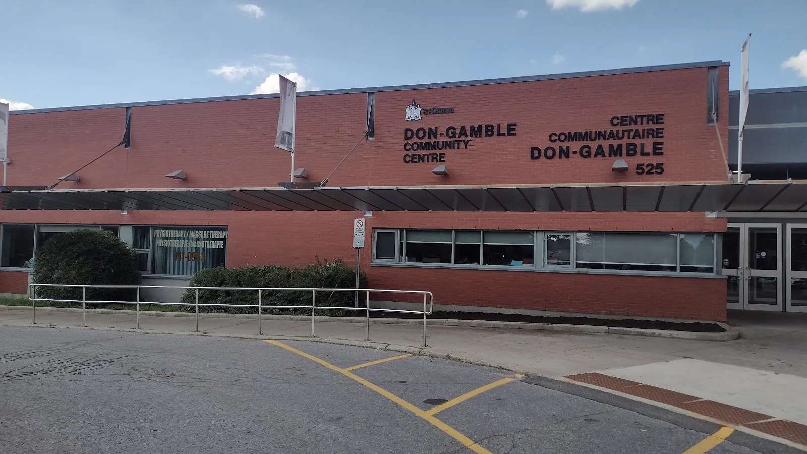 The St-Laurent Complex's long red-brick front at 525 Côté Street, with the Don-Gamble Community Centre name above the windows. — St. Laurent Complex