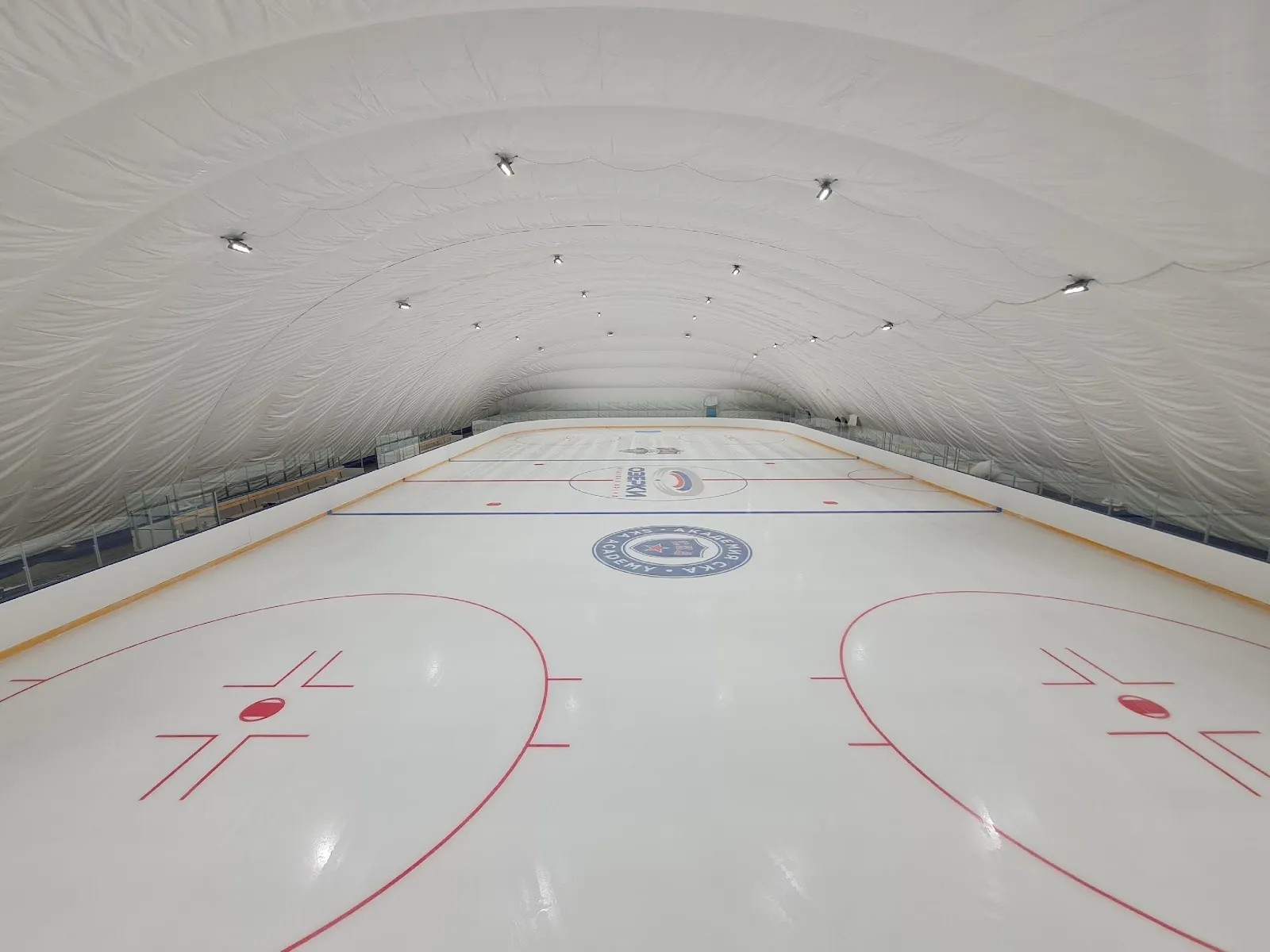 The empty ice sheet under the air-supported dome of the Ozerki ice arena — Ozerki Ice Arena