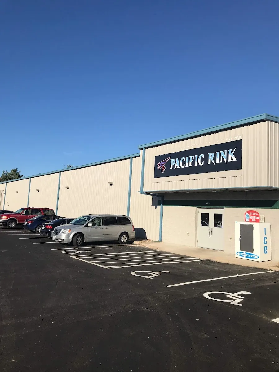 Front of Pacific Ice Rink on Indian Warpath Drive with its sign and the car park — Pacific Ice Rink