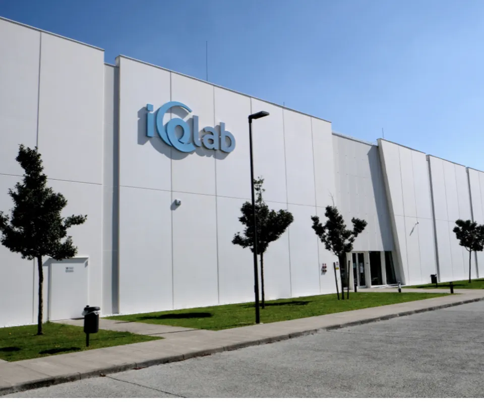 The white IceLab building with its blue logo above a row of young trees and a paved forecourt. — PalaGhiaccio IceLab Bergamo
