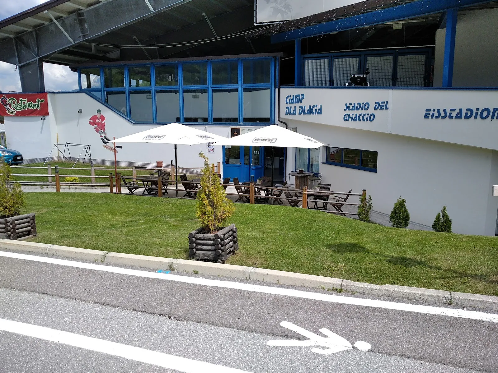 The entrance of the Stadio del Ghiaccio (Eisstadion) in Corvara in Badia with its terrace – Palazzetto del Ghiaccio Corvara (Ice Stadium Corvara)