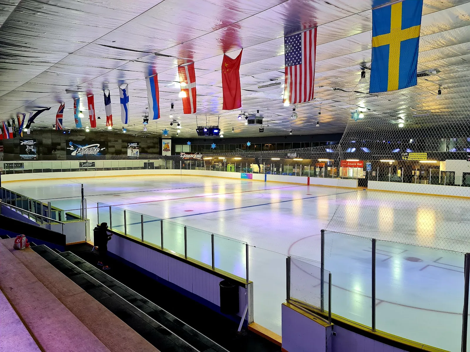 The ice at Paradice Ice Skating Botany under the hanging flags — Paradice Ice Skating Botany