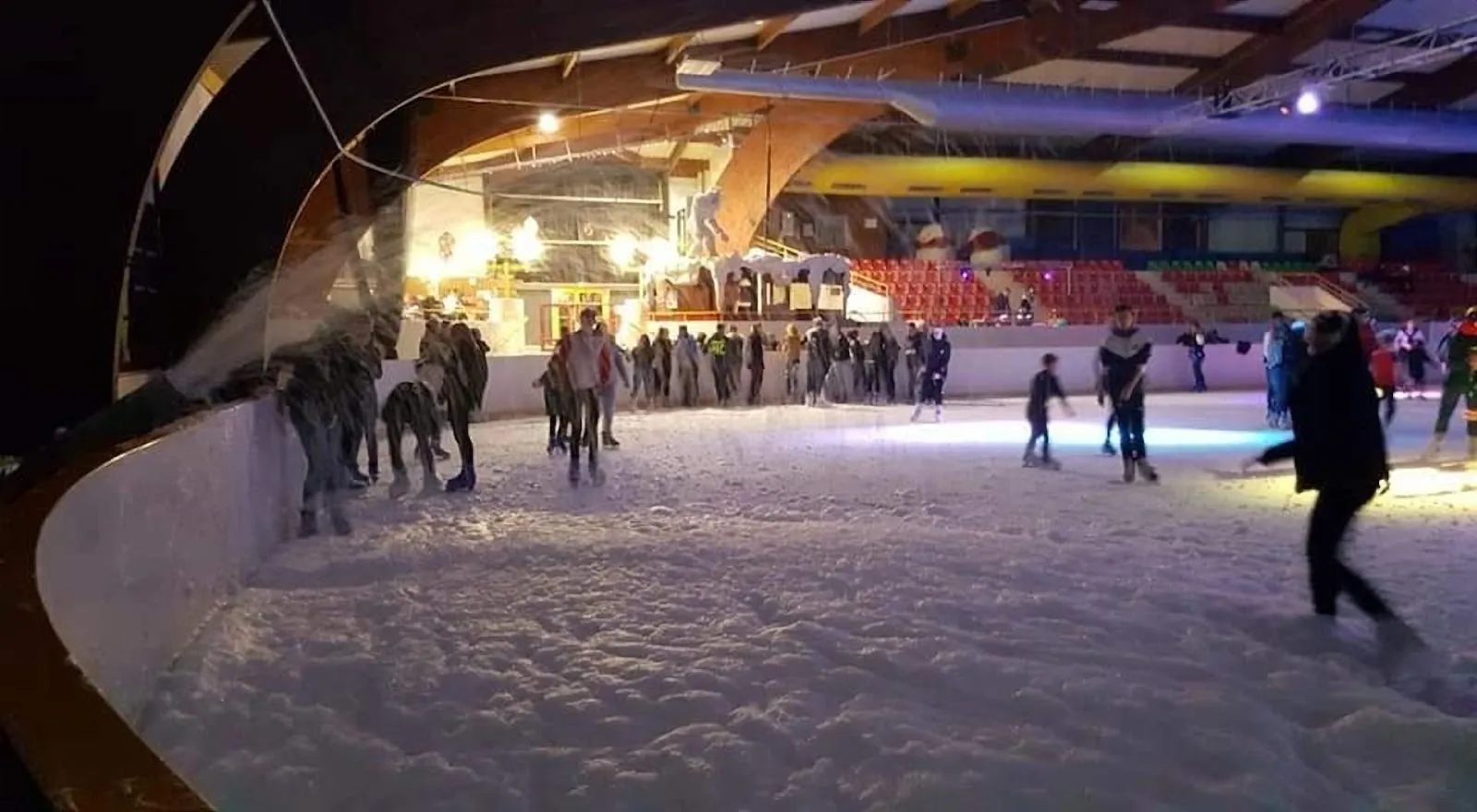 Une séance de patinage public sur la glace de la patinoire de Charleville-Mézières, avec des patineurs le long des bandes sous le toit courbe en bois de la halle. — Patinoire Elena Issatchenko