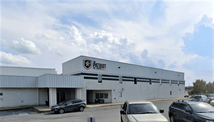 Patriot Ice Center's light-colored front facade and marked entrance. — The Patriot Ice Center