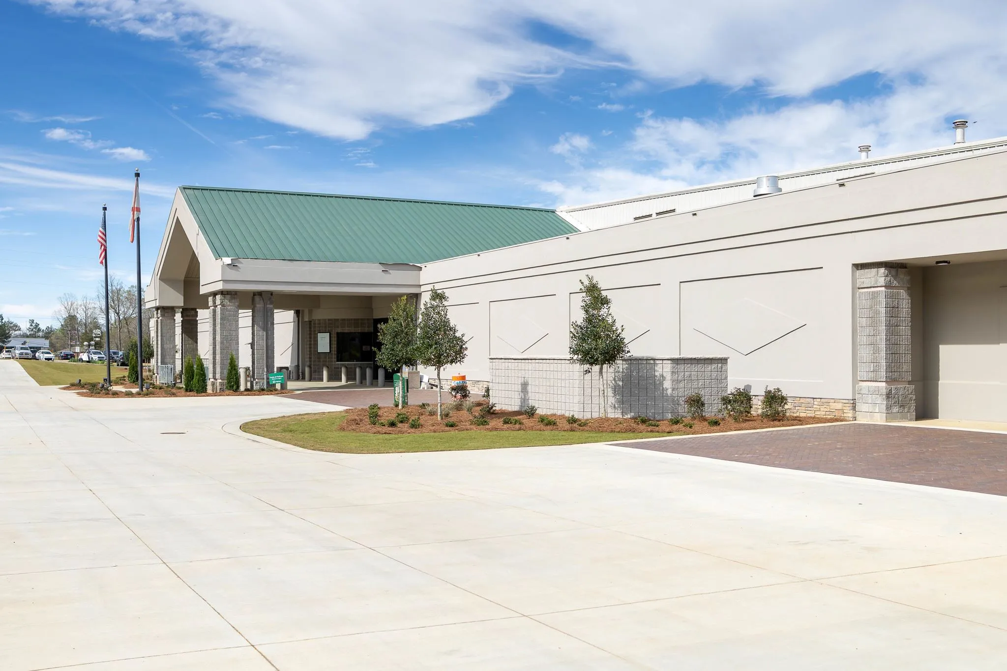 Green gabled roof over the covered entrance drive — Pelham Civic Complex & Ice Arena