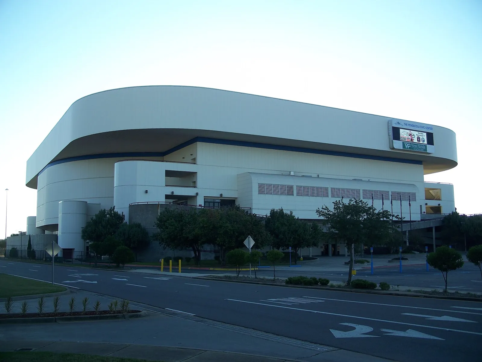 The curved white concrete exterior of the Pensacola Bay Center, shown here under its former Pensacola Civic Center name — Pensacola Bay Center