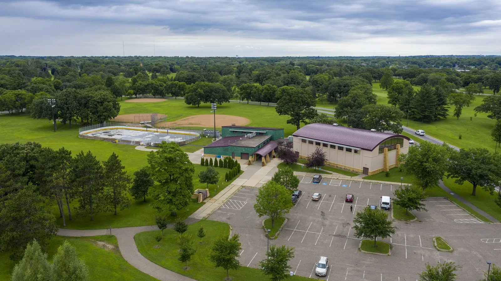 Aerial view of the Phalen Recreation Center building, with the park's outdoor rink area beside it, in summer — Phalen Park Outdoor Rinks