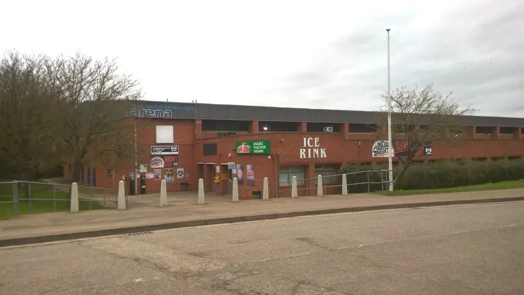 The red-brick front of Planet Ice Peterborough in Bretton, with the ICE RINK sign above the entrance. — Planet Ice Peterborough