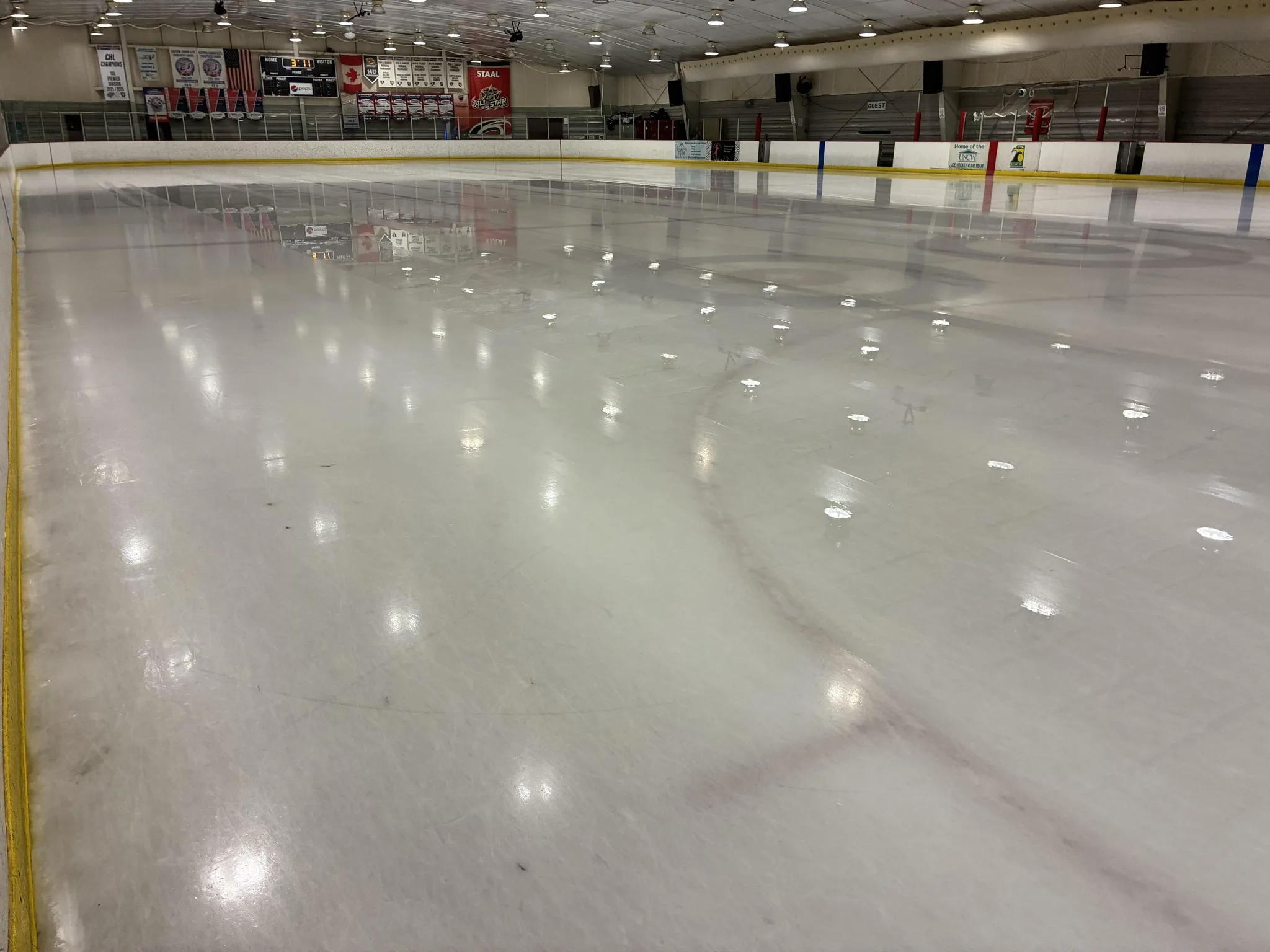 Fresh ice the length of the rink, dasher ads along the far side — Polar Ice Wilmington