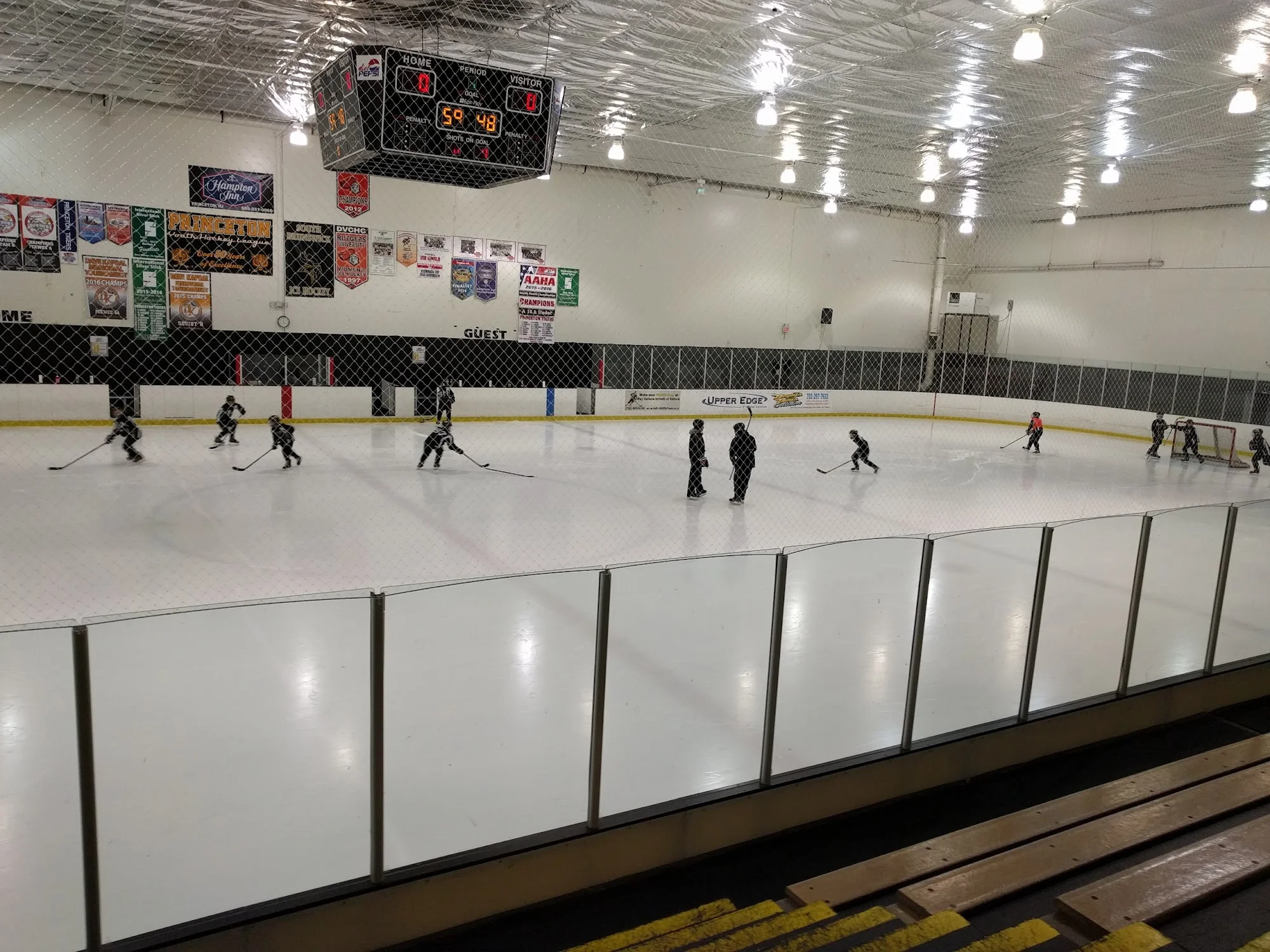 Hockey practice at ProSkate, viewed through the spectator-area safety net. — Pro Skate