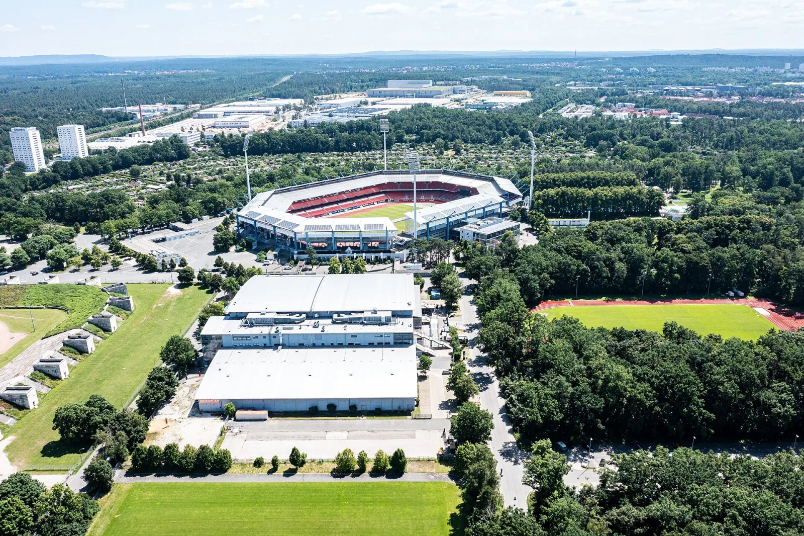 Aerial view of the arena (centre, white roofs) beside the Max-Morlock-Stadion, 2021 — PSD Bank Nürnberg ARENA