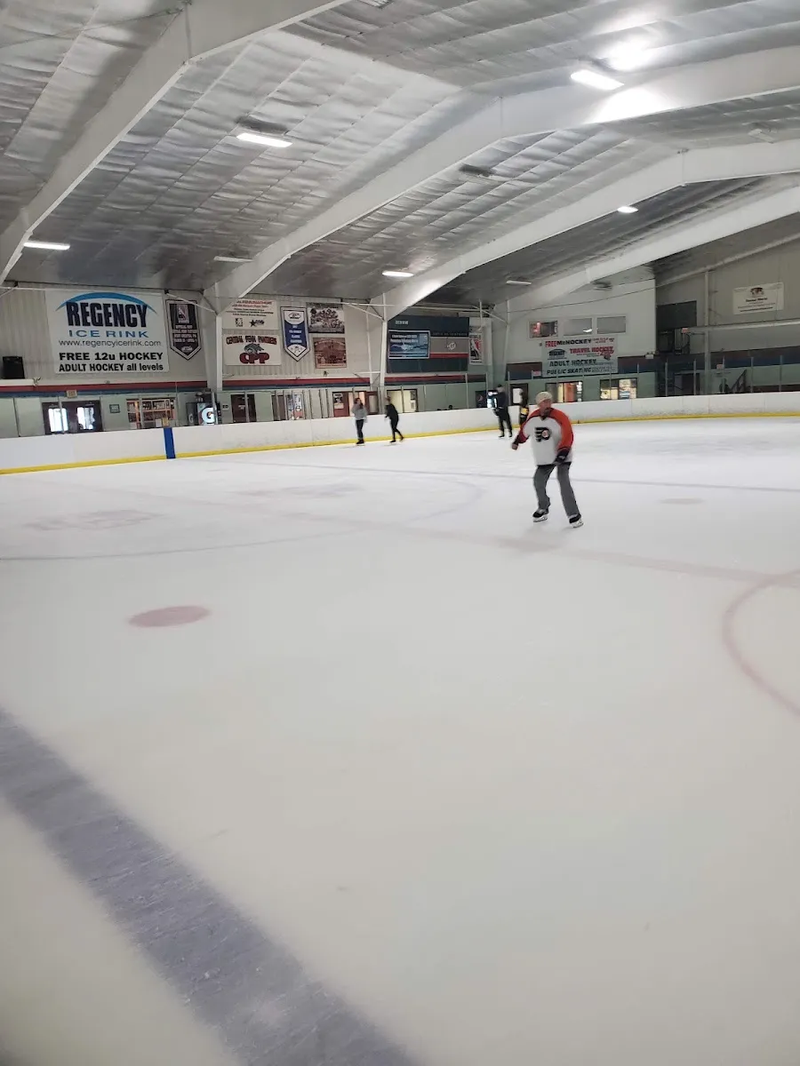 The ice at Regency Ice Rink with a few skaters in the distance — Regency Ice Rink