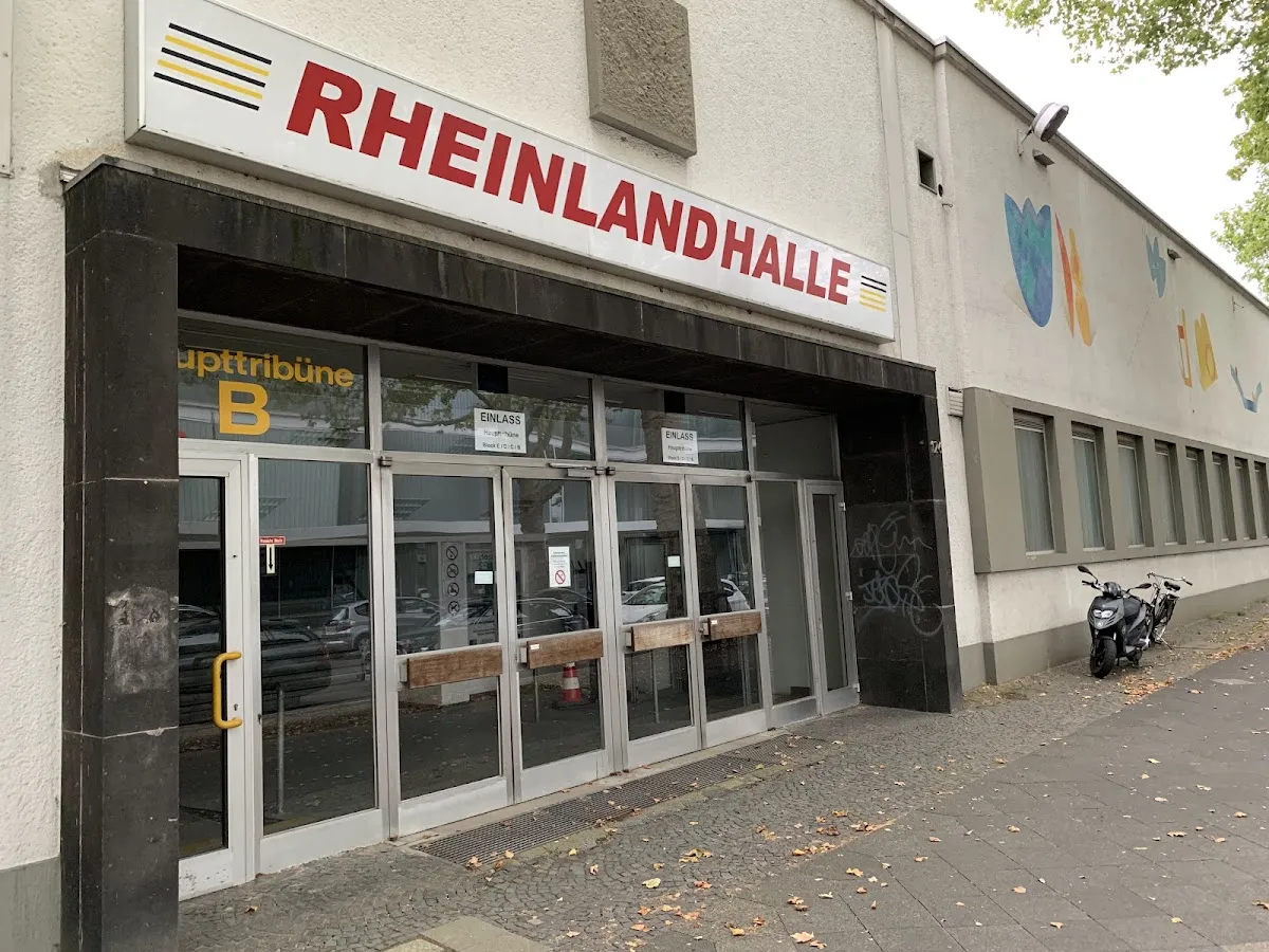The street front of the Rheinlandhalle in Krefeld with its red lettering over the entrance. — Rheinlandhalle Krefeld