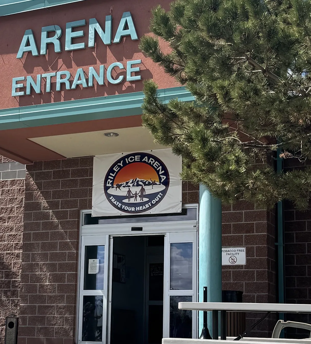 The Arena Entrance of the Cody events center, with the Riley Ice Arena banner over the doors — Riley Arena