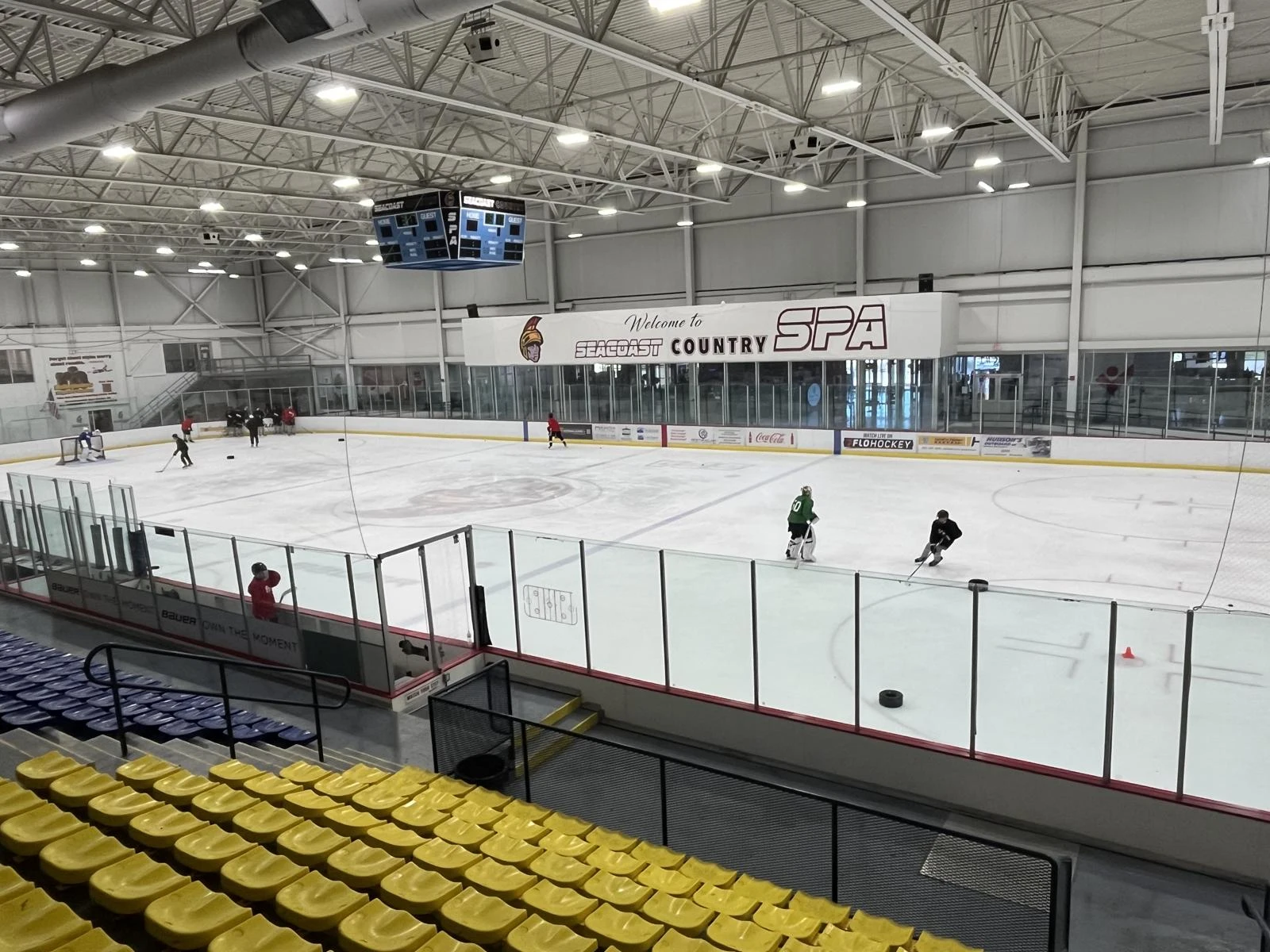 A wide view of the ice at The Rinks at Exeter beneath Seacoast and SPA signage. — The Rinks at Exeter