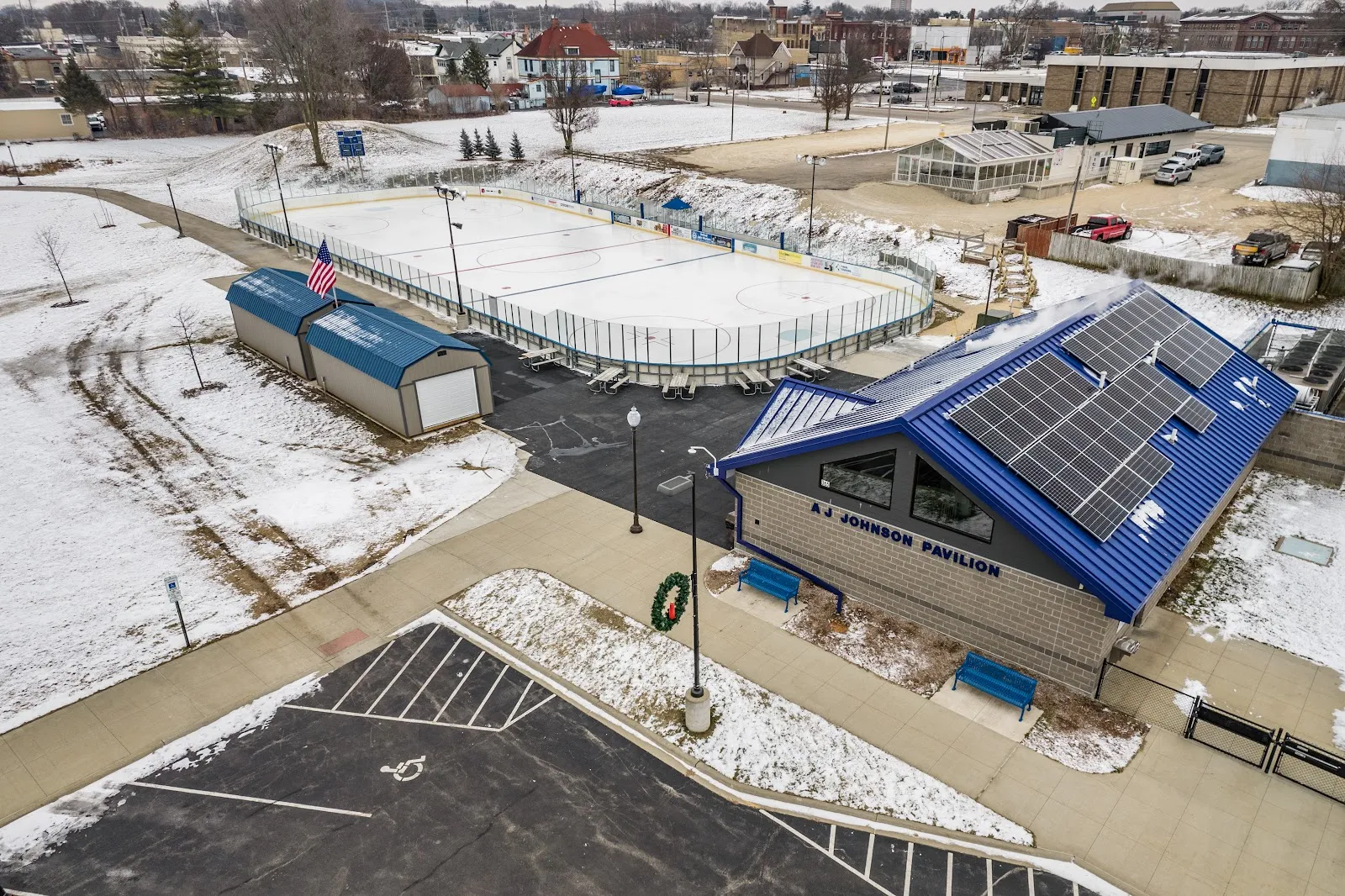 Aerial view of the A.J. Johnson Pavilion warming house and the outdoor rink in Doty Park. — Riverside Ice Arena