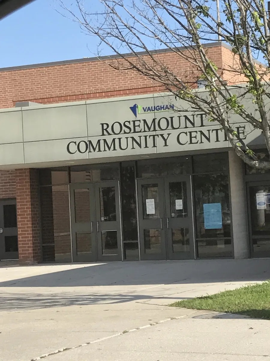 The brick front of the Rosemount Community Centre with its entrance doors under the Vaughan and Rosemount Community Centre sign, a paved walk and a bare tree in front. — Rosemount Community Centre (Vaughan)