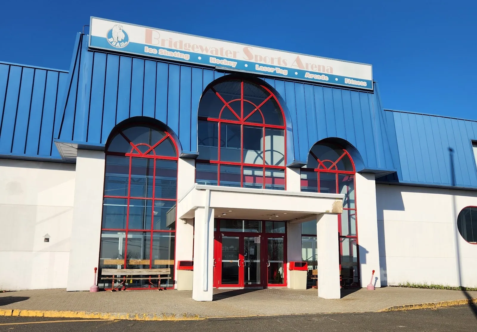 The arena entrance at 1425 Frontier Road, red-framed arched windows under a blue roof and a Bridgewater Sports Arena sign — RSG Arena at Bridgewater