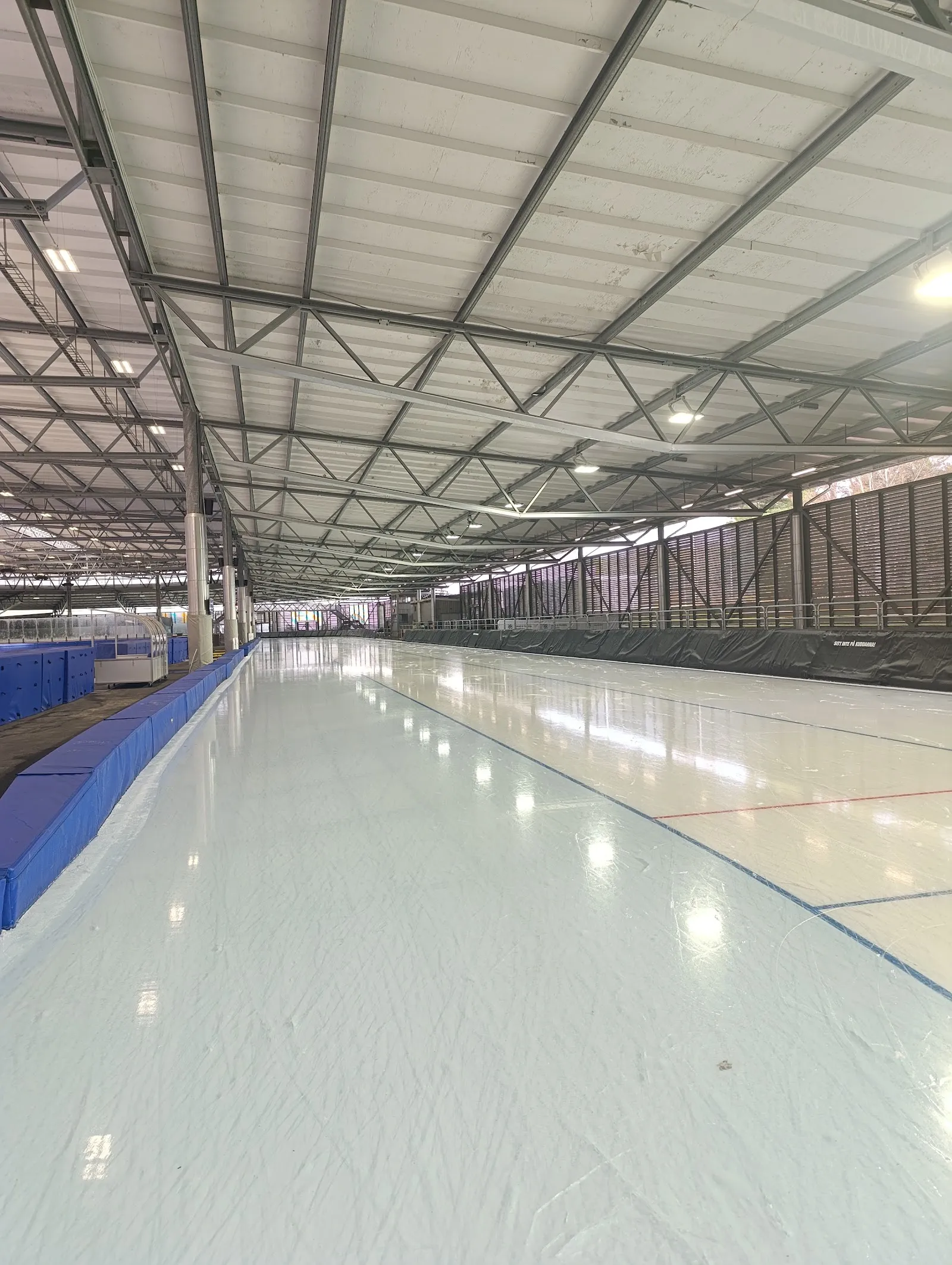 The empty speed-skating ice of Ruddalens ishall under its steel roof — Ruddalens ishall