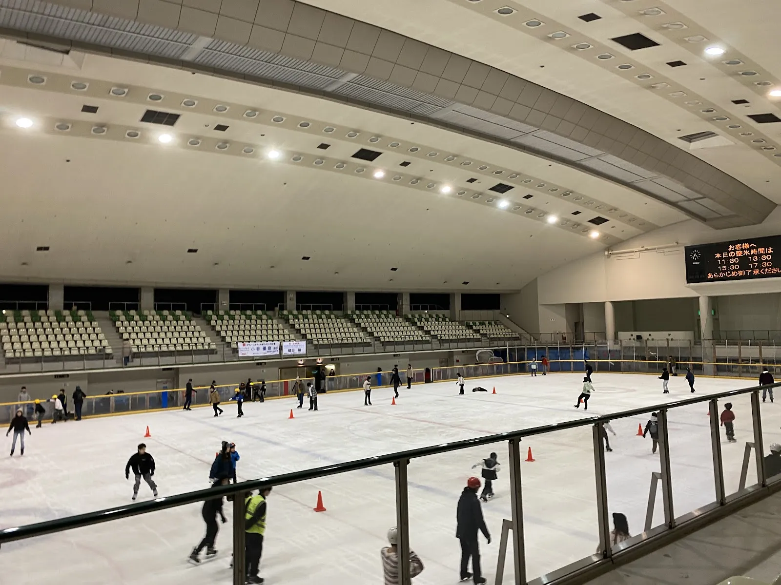 The main rink at Sagamihara Ginga Arena during a public session, with skaters spread across the ice, traffic cones and an empty gallery behind. — Sagamihara Ginga Arena
