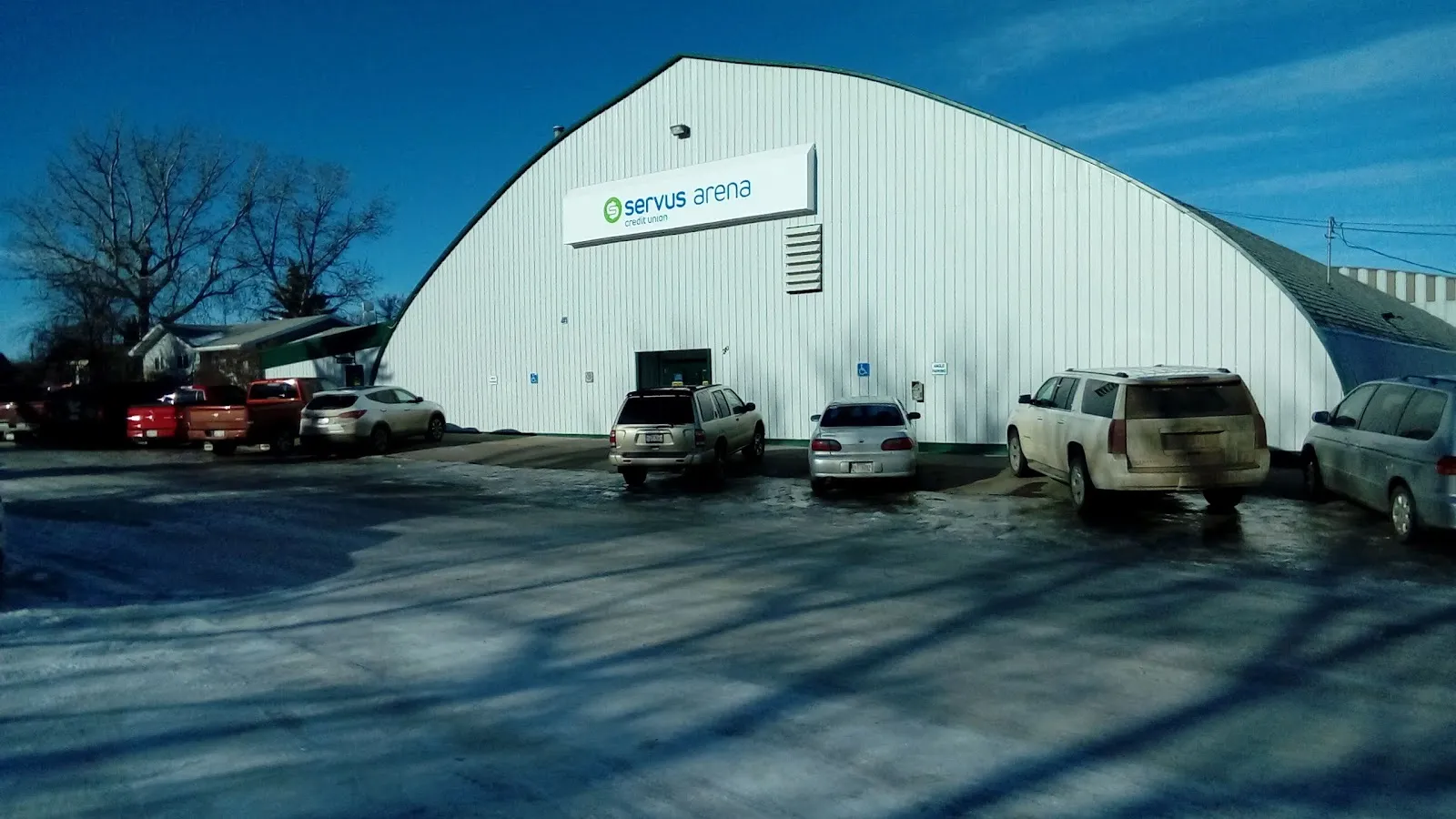 The arched Servus Community Arena building in winter — Servus Community Arena