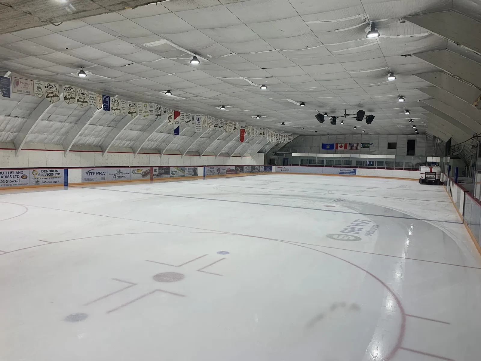 The ice surface and arched roof of the Servus Community Arena — Servus Community Arena