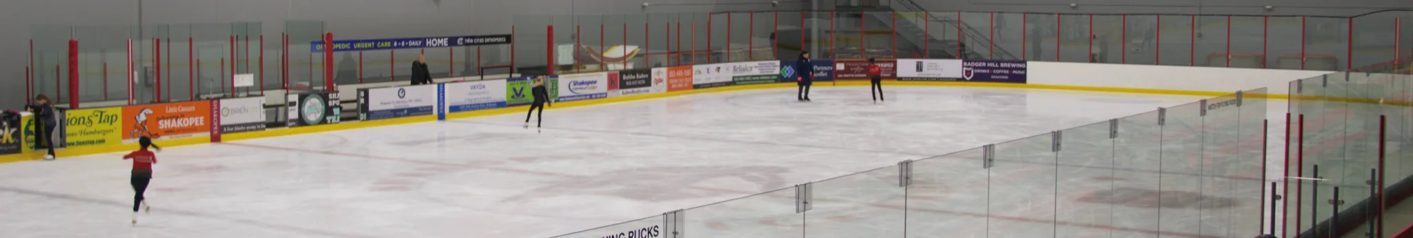 Wide view across most of the ice sheet during a figure-skating session — Shakopee Ice Arena