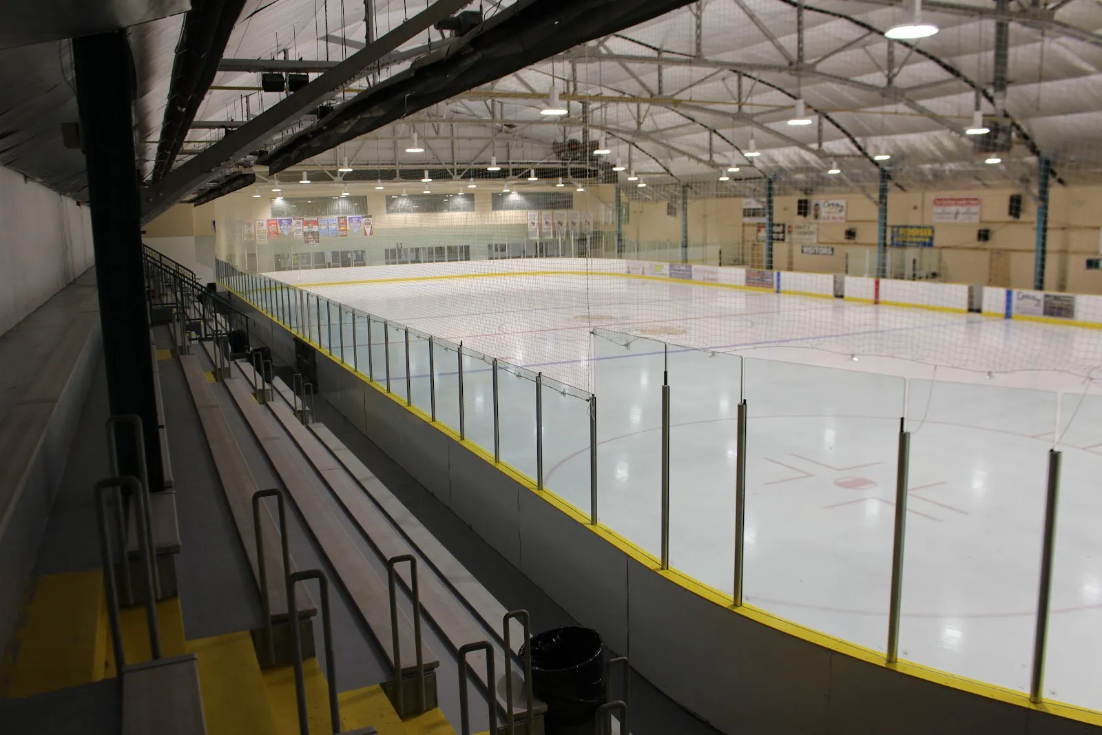 The empty Shelley Herbert-Shea Memorial Arena ice seen from the bleachers along the side boards. — Shelley Herbert-Shea Memorial Arena (Haileybury)