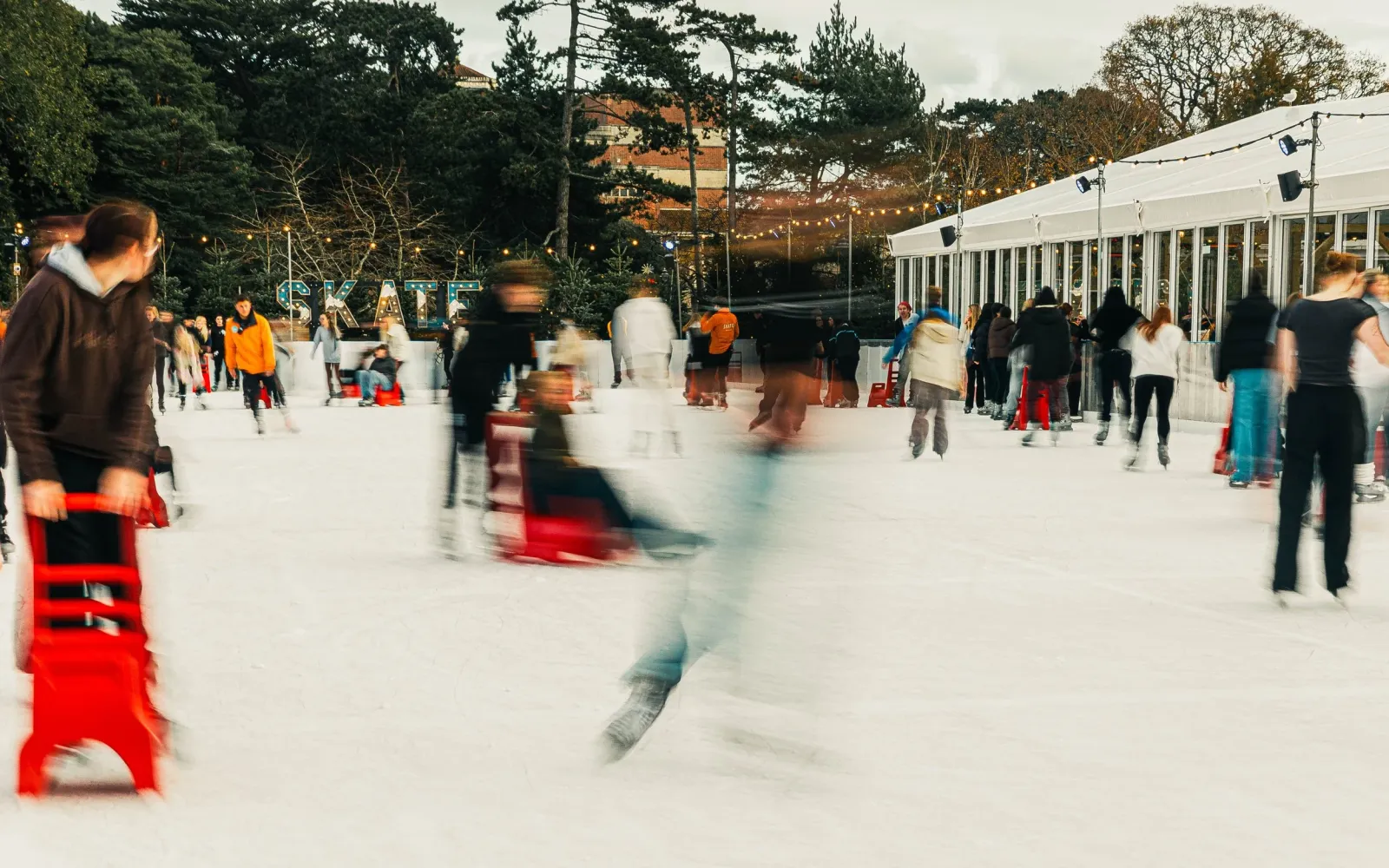 Skaters and skate aids on the ice at SKATE Bournemouth (the operator's photo) — SKATE Bournemouth (Lower Gardens)