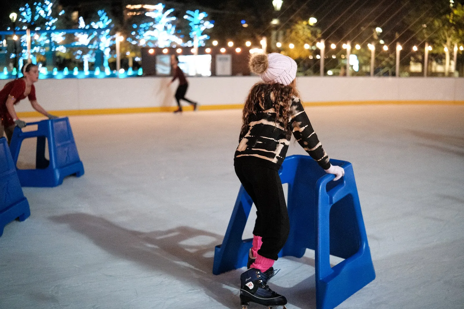 A skater with a blue skate helper on the Skate City Springs ice — Skate City Springs