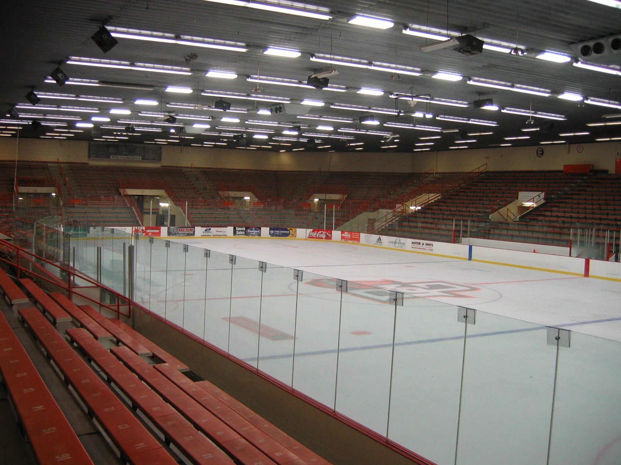 Empty rink from behind the glass at one corner — Slater Family Ice Arena