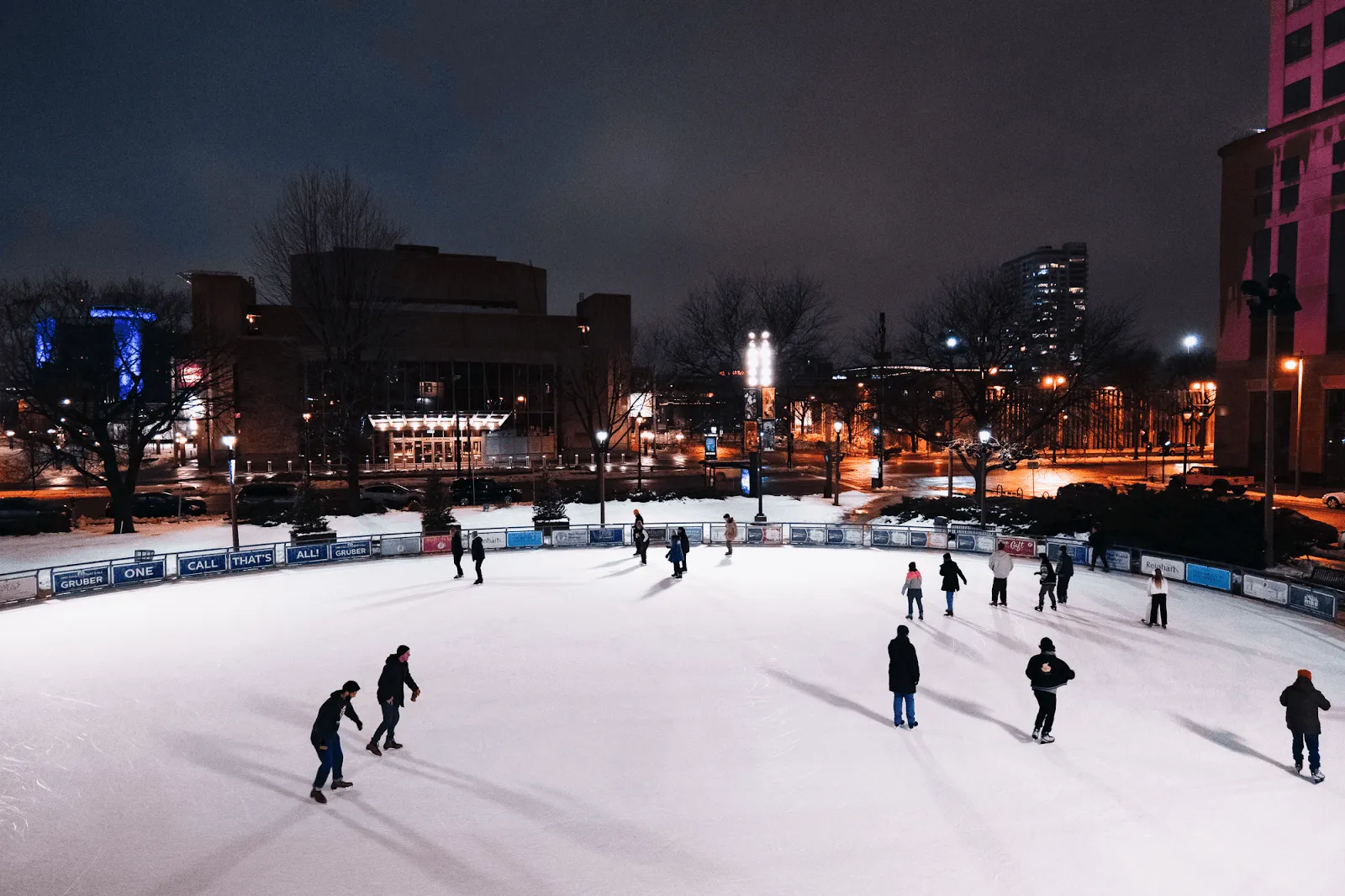 Skaters on the Slice of Ice rink at night, Red Arrow Park, Milwaukee (Google Maps listing photo) — Slice of Ice at Red Arrow Park
