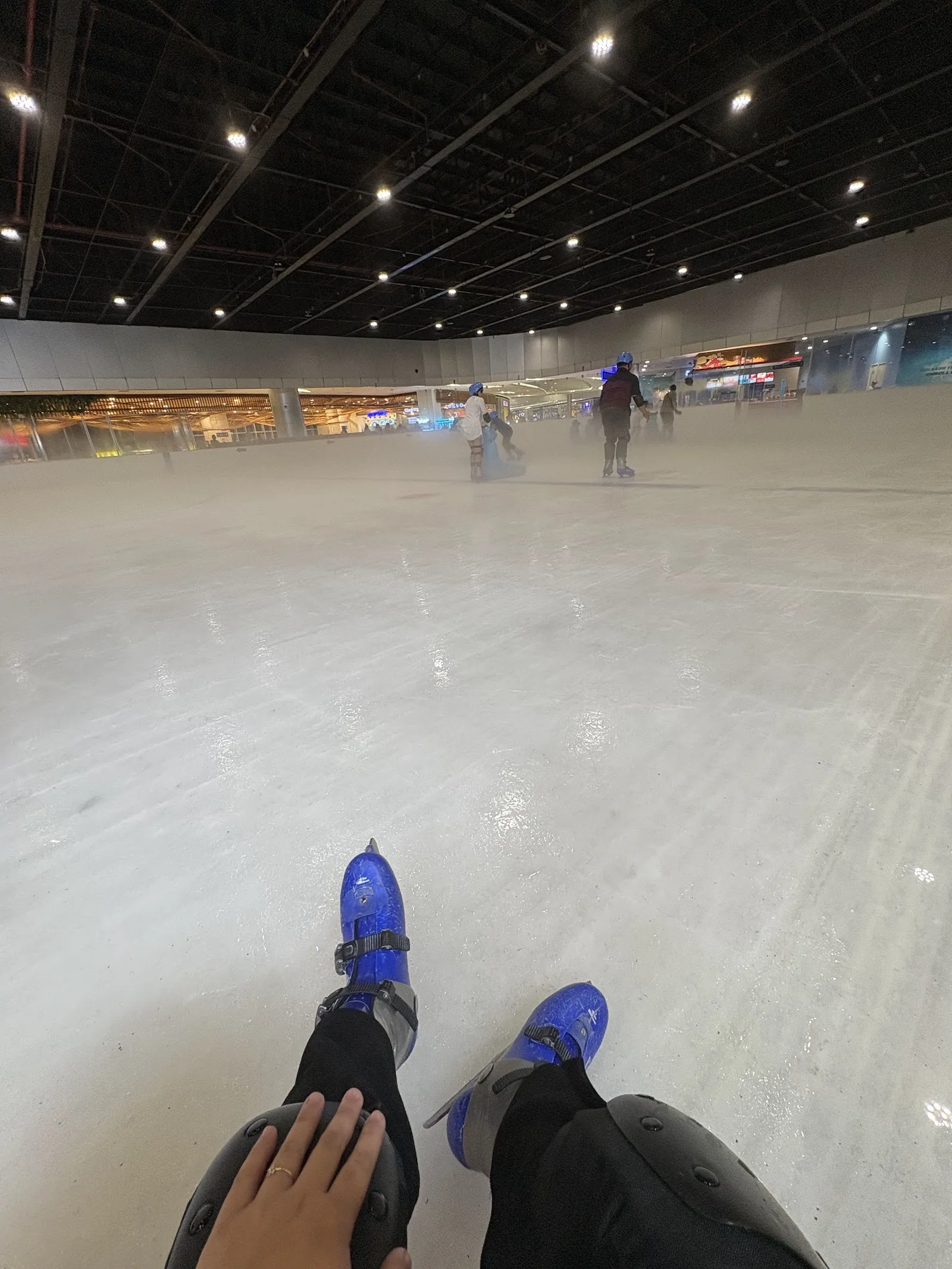 The wide sheet at SM Skating Seaside City Cebu under a black exposed ceiling, with skaters in the distance. — SM Skating Seaside City Cebu