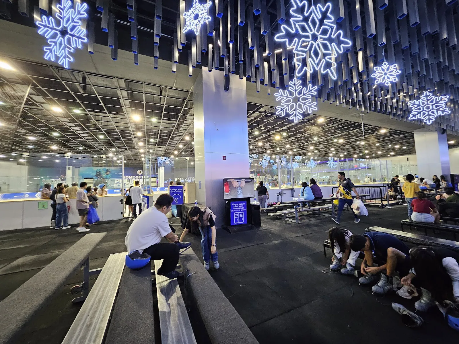 The skating hall at SM Mall of Asia seen from the entrance benches, with the rink glass and ceiling decorations. — SM Skating Mall of Asia