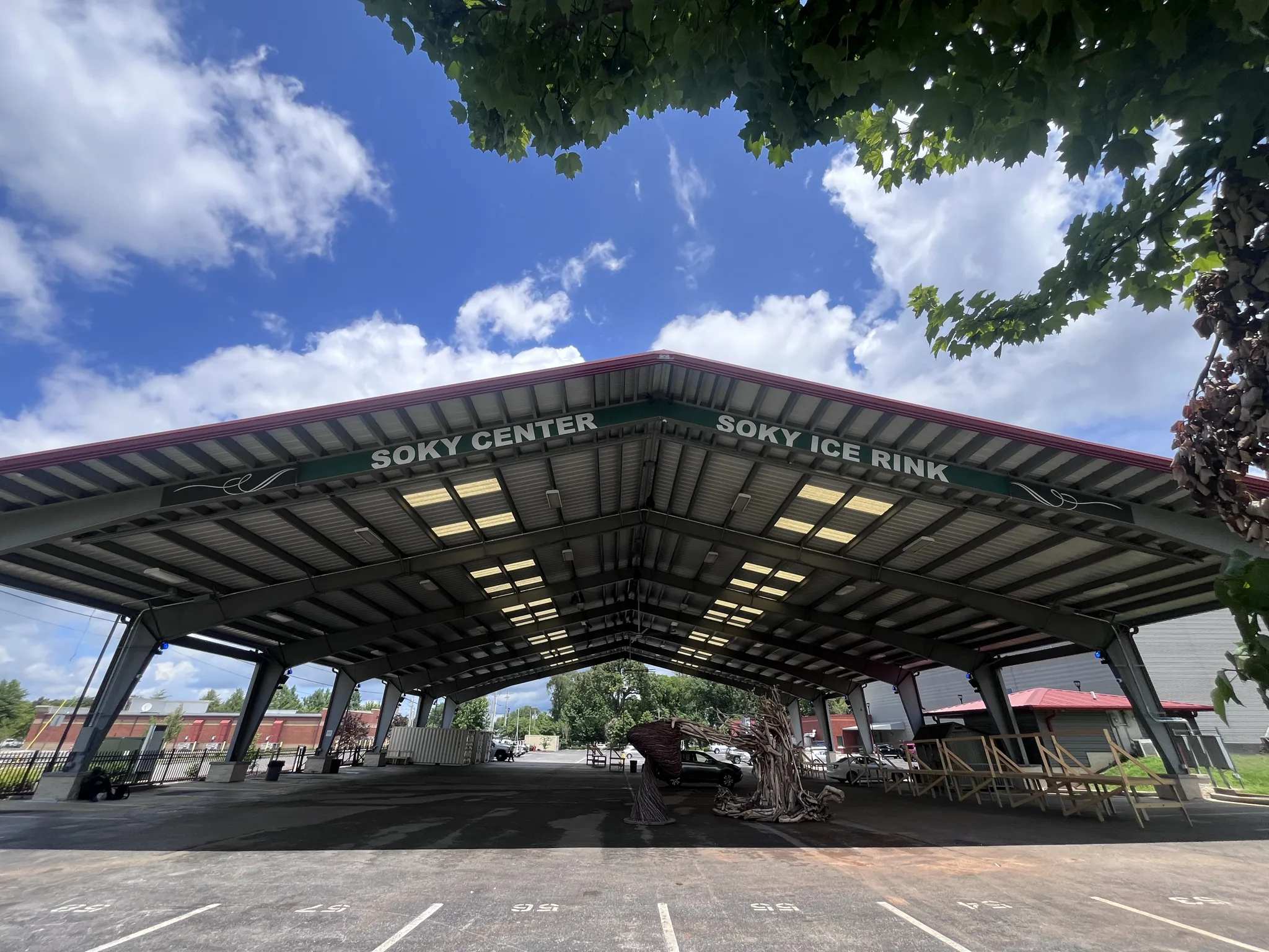 Open-sided SoKY pavilion seen from the parking lot on a bright summer day — SoKY Ice Rink