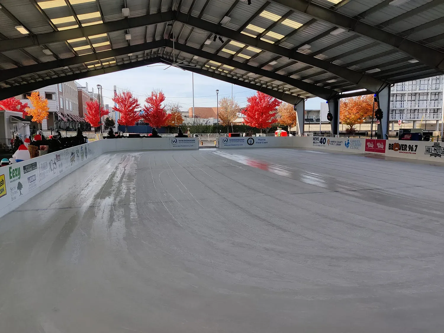 Full seasonal ice sheet under the SoKY pavilion roof on an autumn afternoon — SoKY Ice Rink