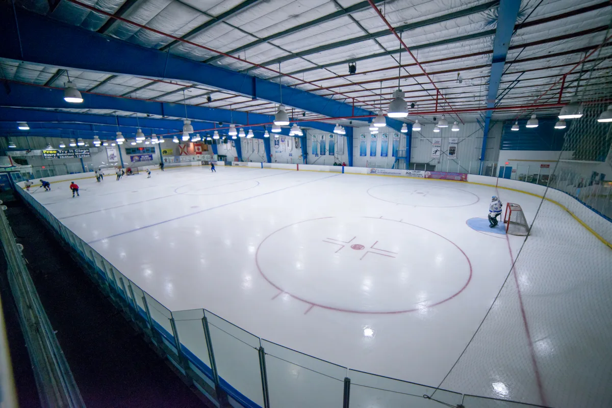 Whole ice sheet seen from the corner over the glass — Space Coast Iceplex