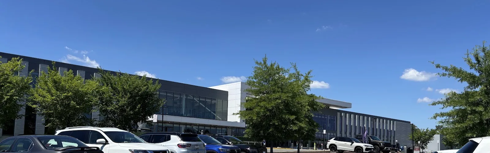 The St. James sports complex in Springfield: the long glass-fronted building with its white-framed entrance block, seen across the parking lot — The St. James (Springfield)