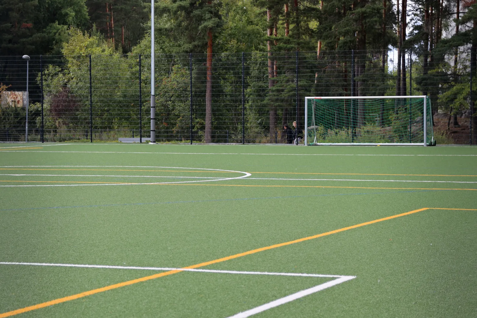 The Suikkilan field in summer, an artificial-turf pitch with goals; the City of Turku freezes its fields into skating fields in winter. — Suikkilan luistelukenttä